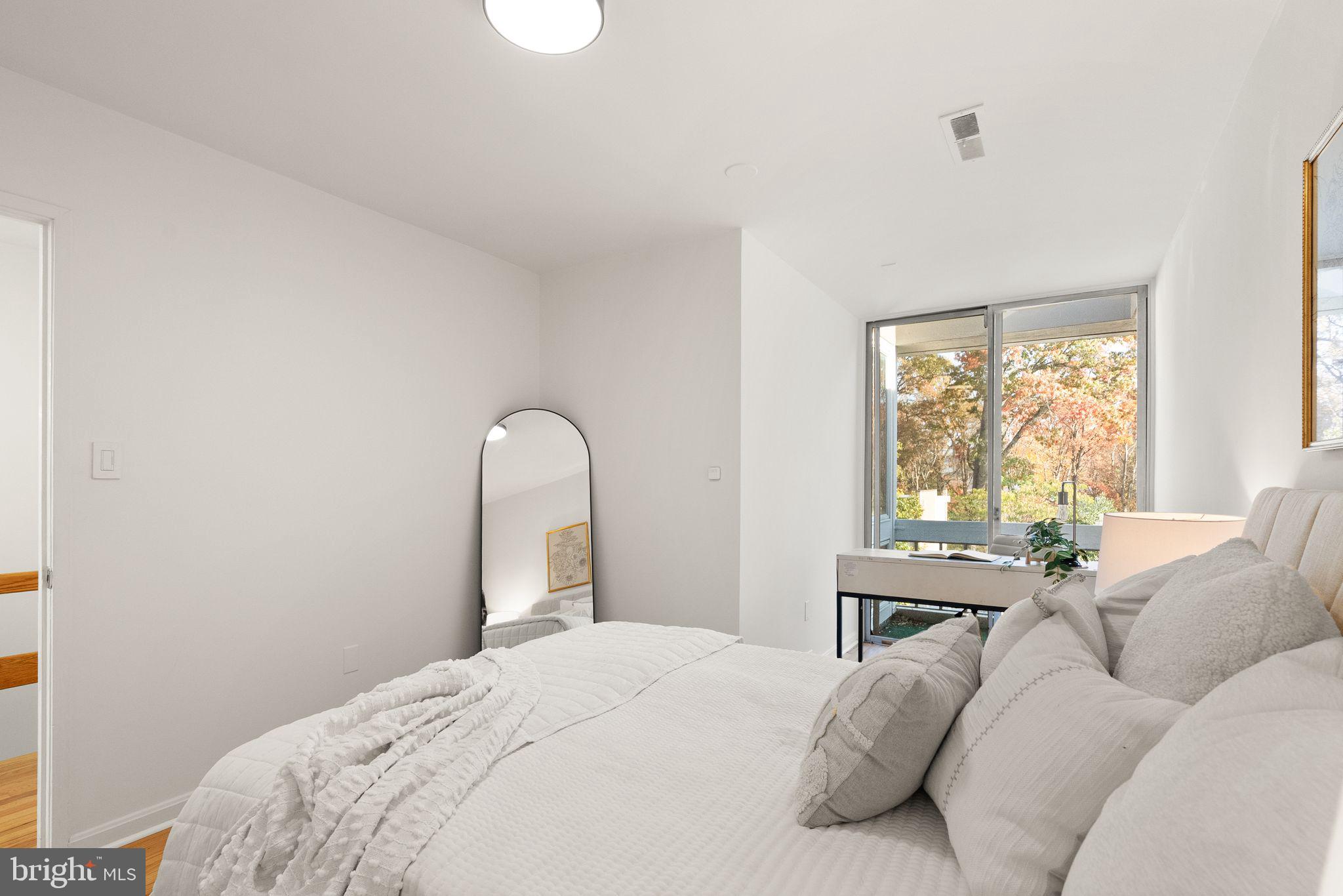 11577 Maple Ridge Road Reston, VA 20190 - Photo 35 of 48 a bedroom with a bed and a window