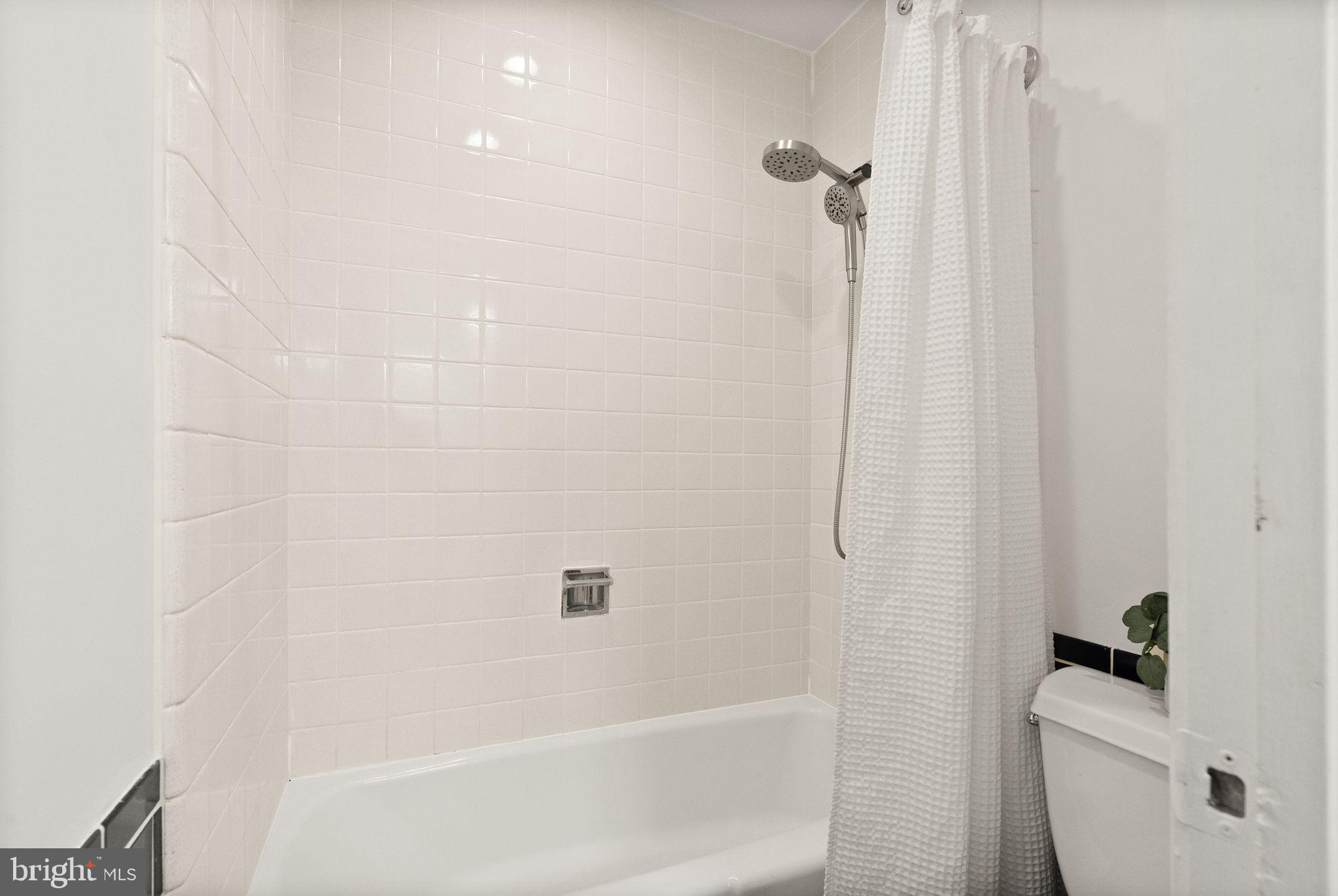 11577 Maple Ridge Road Reston, VA 20190 - Photo 41 of 48 a bathroom with a bathtub a toilet and a shower
