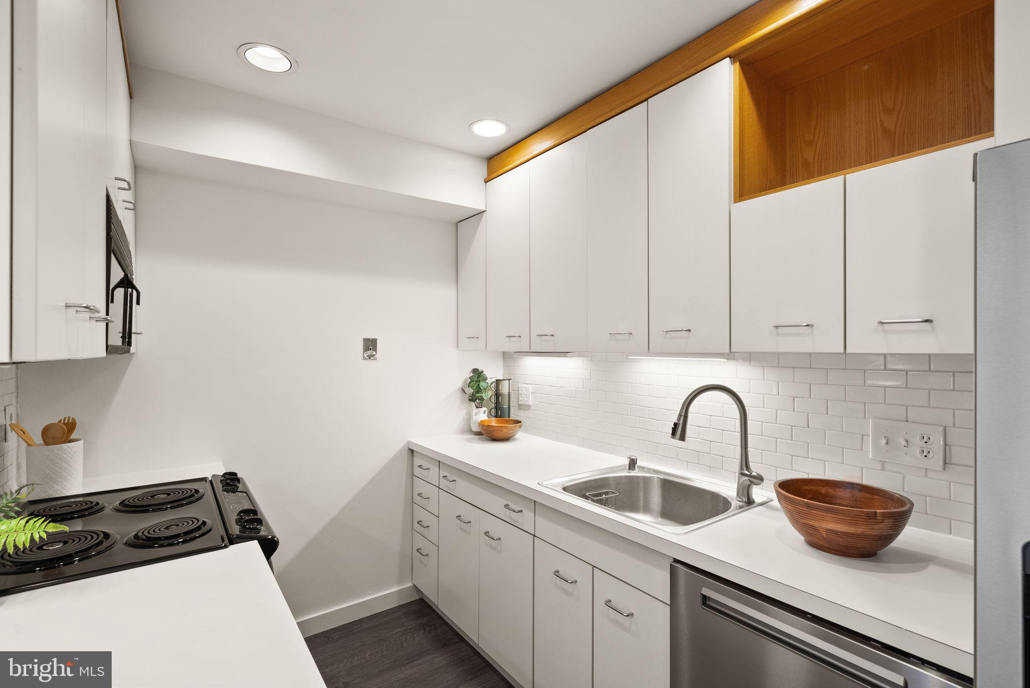 11577 Maple Ridge Road Reston, VA 20190 - Photo 10 of 48 a kitchen with sink a stove and cabinets