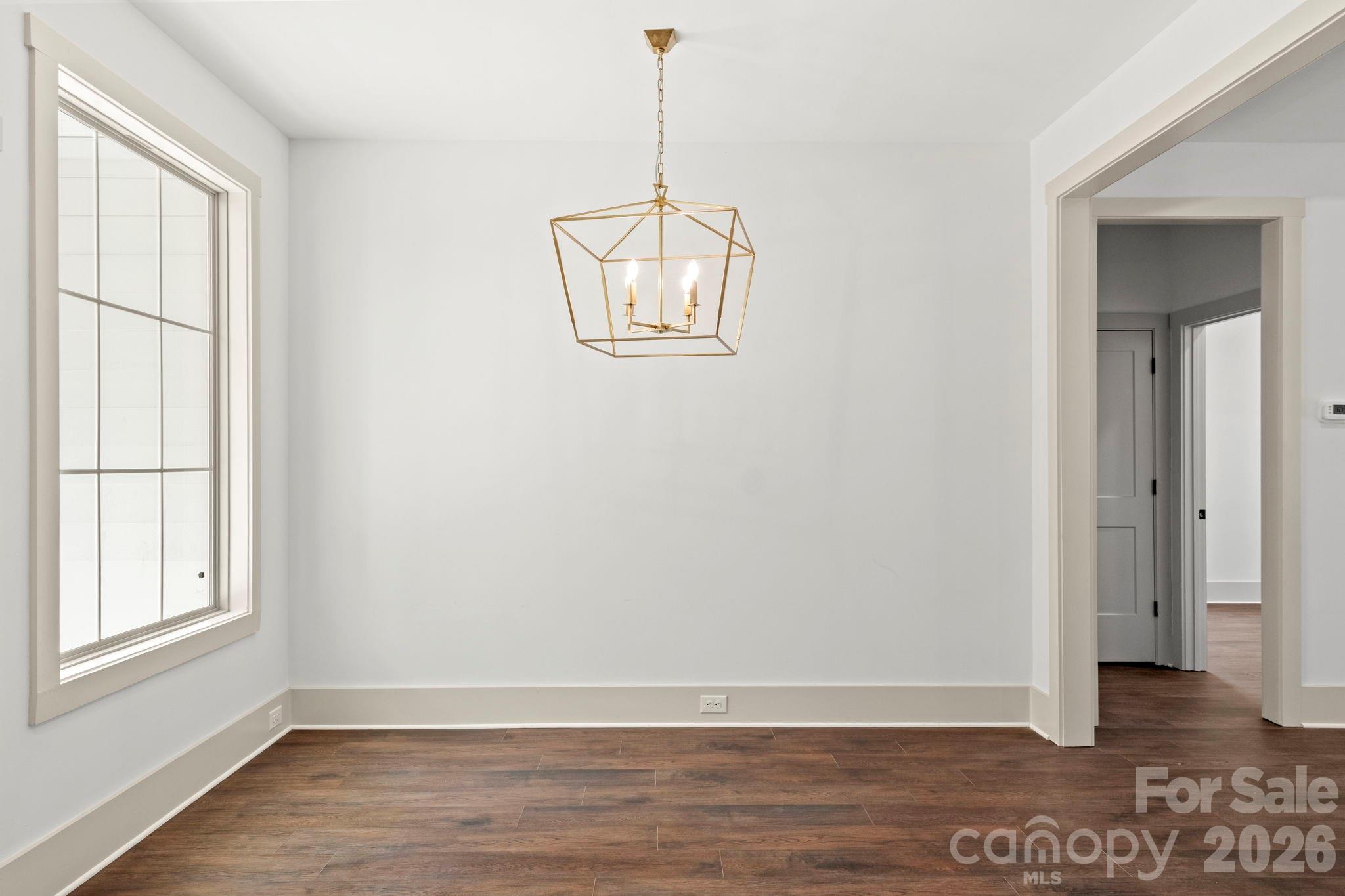 1167 Tirzah Road Rock Hill, SC 29732 - Photo 9 of 25 a view of an empty room with wooden floor and a window