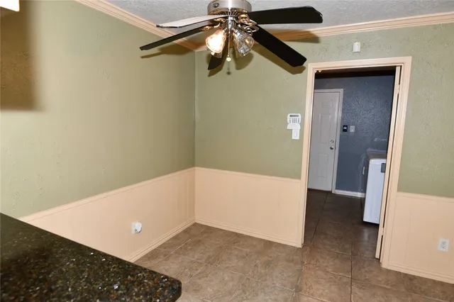 an empty room with closet and fan