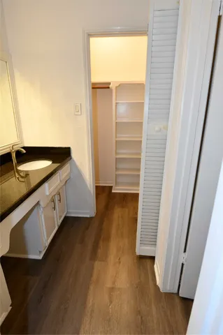 a view of a room with a chandelier fan
