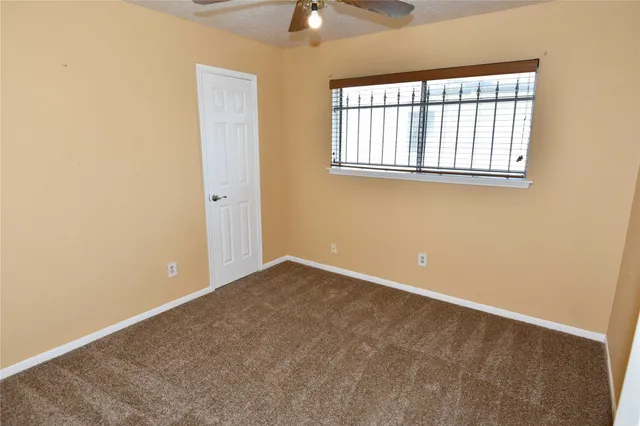 a utility room with a closet and mirror