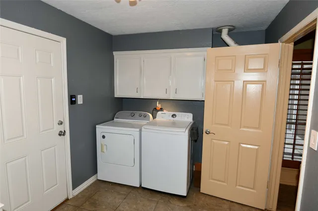 a view of a backyard with table and chairs under an umbrella