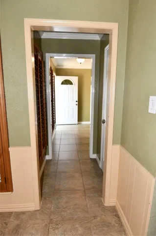 an empty room with windows cabinet and flat screen tv