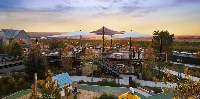 a view of a chairs and table in front of a house
