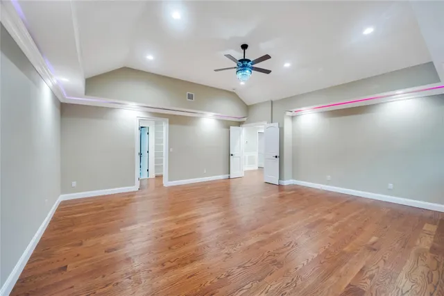 a view of an empty room with a ceiling fan