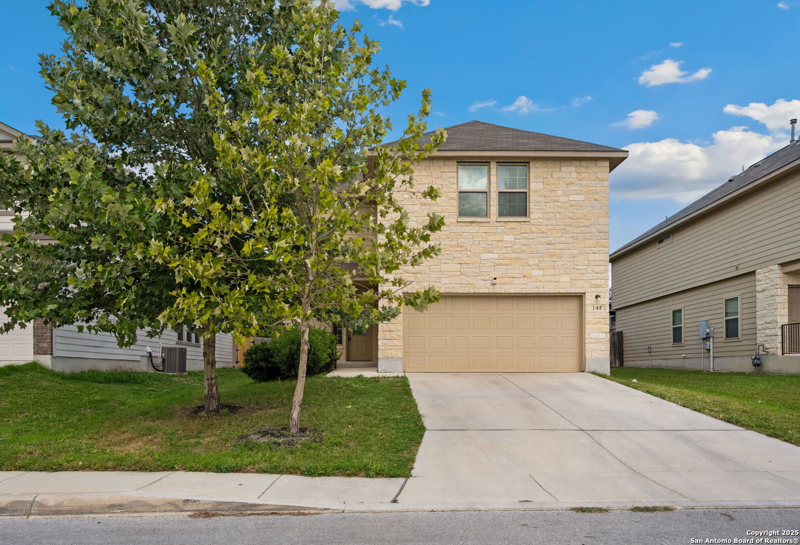 148 Hunters Spring San Antonio, TX 78253 - Photo 1 of 16 a front view of a house with a garden and trees