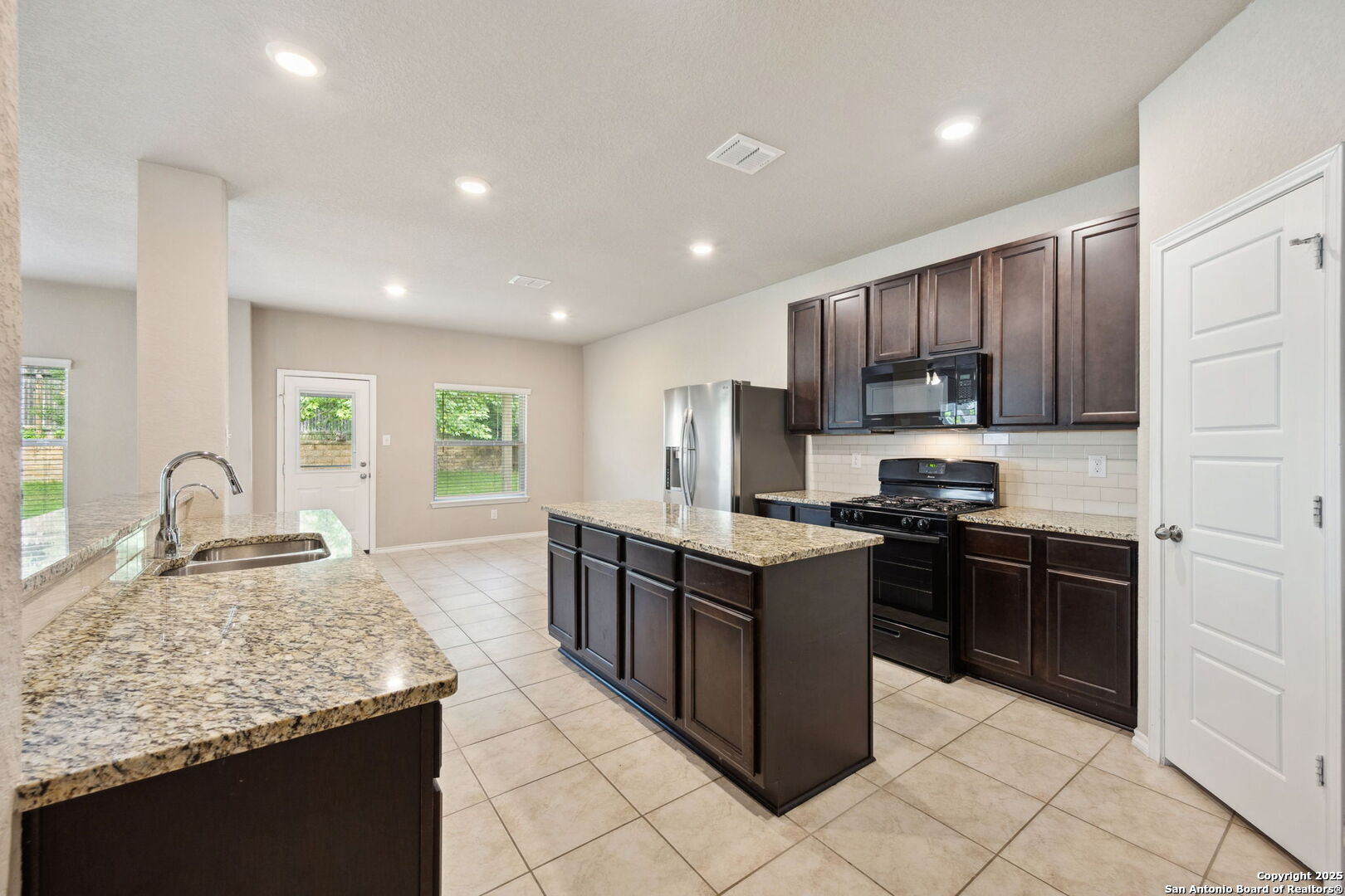 148 Hunters Spring San Antonio, TX 78253 - Photo 2 of 16 a kitchen with stainless steel appliances granite countertop a stove top oven a sink dishwasher and a refrigerator