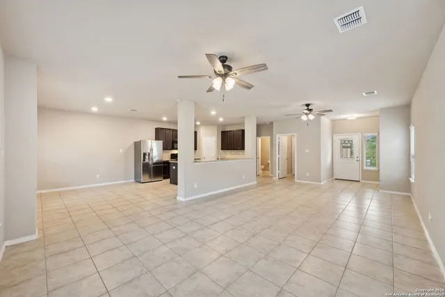 a view of a kitchen with furniture and a ceiling fan