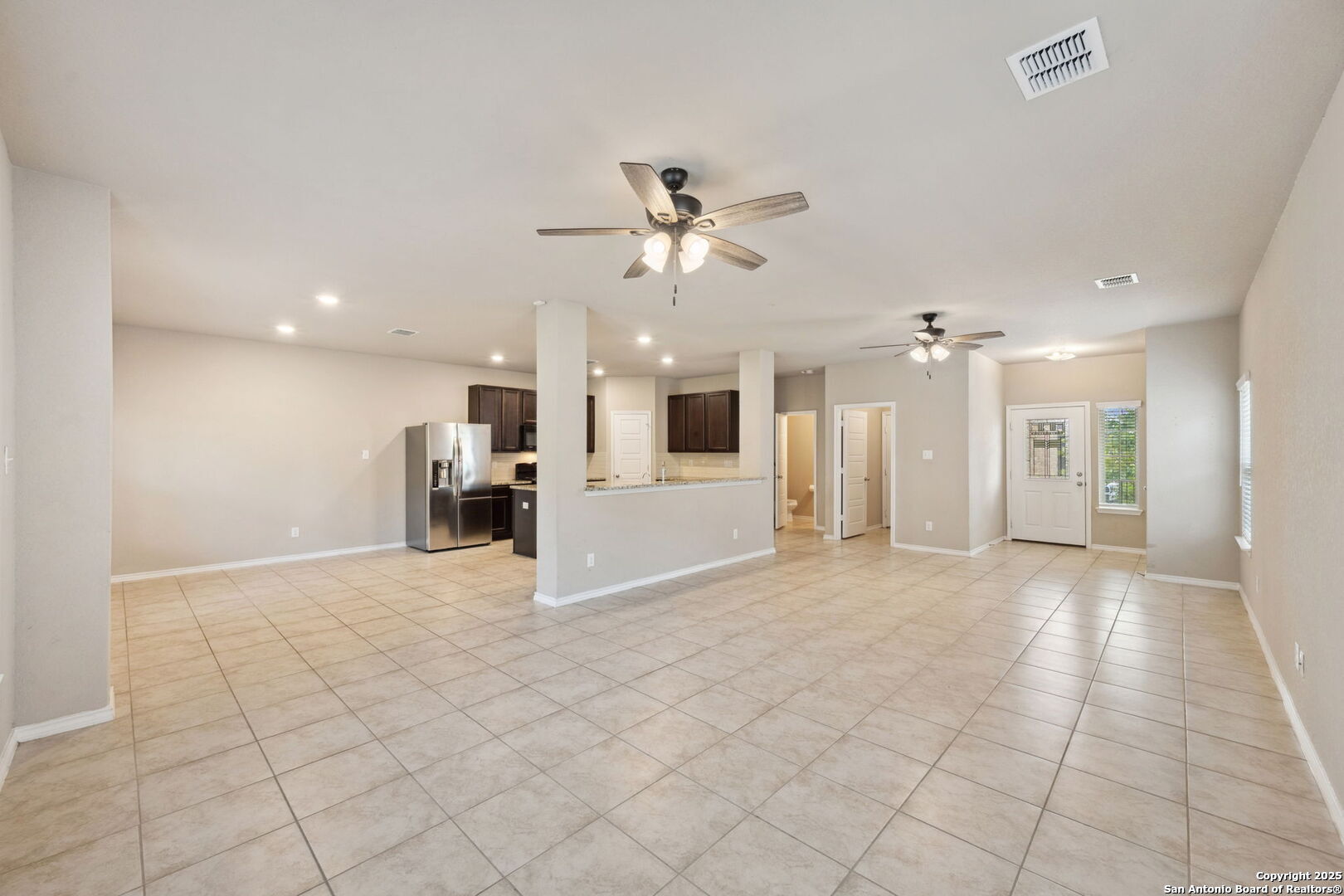 148 Hunters Spring San Antonio, TX 78253 - Photo 4 of 16 a view of a kitchen with furniture and a ceiling fan