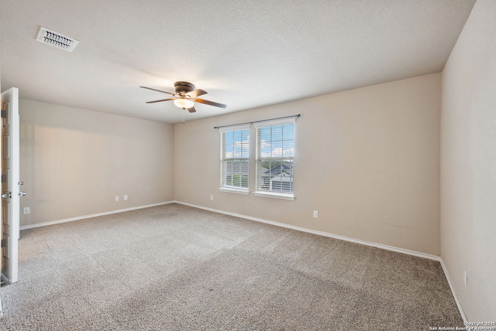 148 Hunters Spring San Antonio, TX 78253 - Photo 7 of 16 a view of a room with a window and a ceiling fan