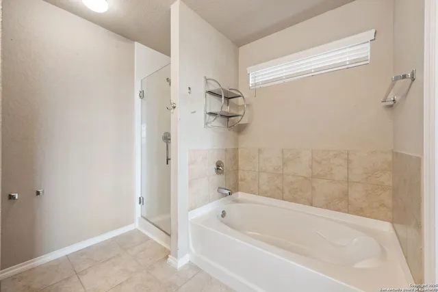a white bath tub sitting next to a shower