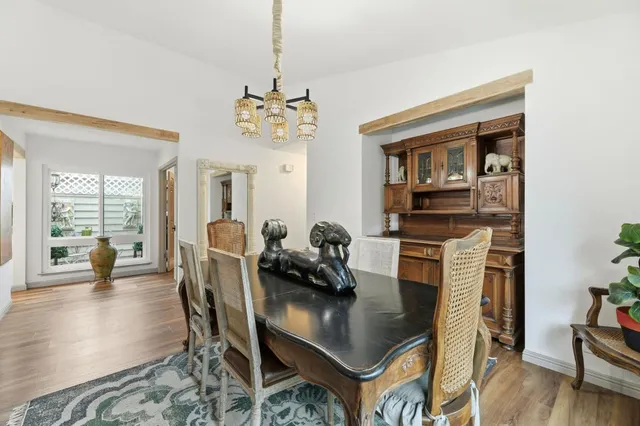 a view of a dining room with furniture wooden floor and chandelier