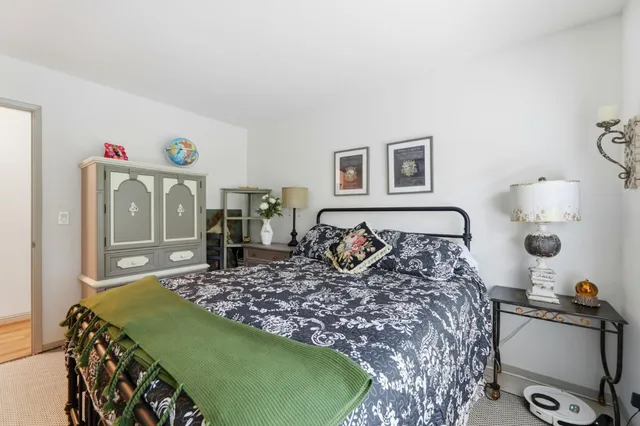 a bedroom with a bed and with furniture