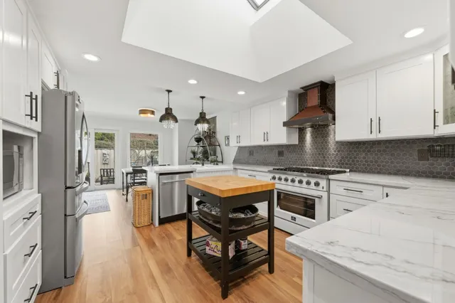 a kitchen with a stove a sink and a refrigerator