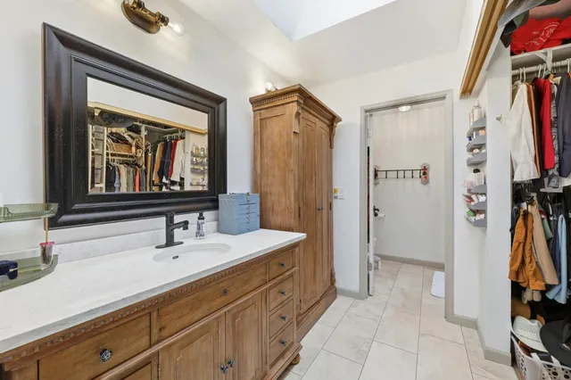 a bathroom with a sink a mirror and a shower