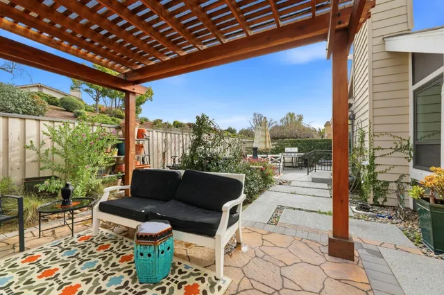 a balcony with furniture and a potted plant
