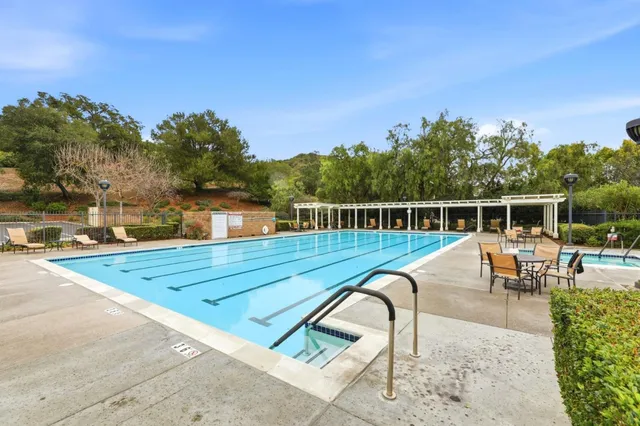 a view of a swimming pool with outdoor seating