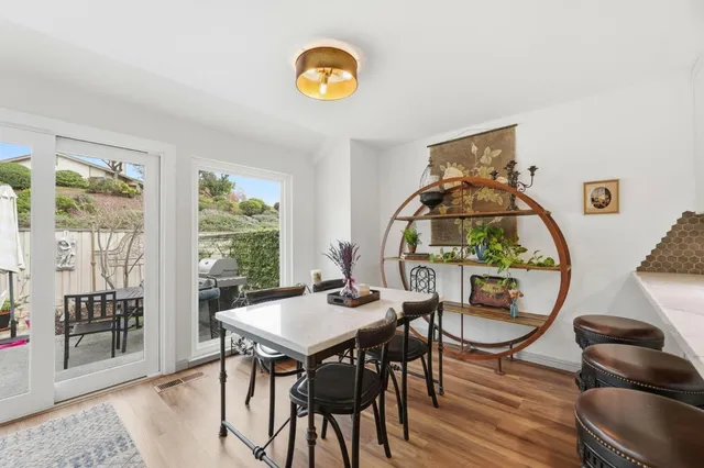 a view of a dining room with furniture window and wooden floor