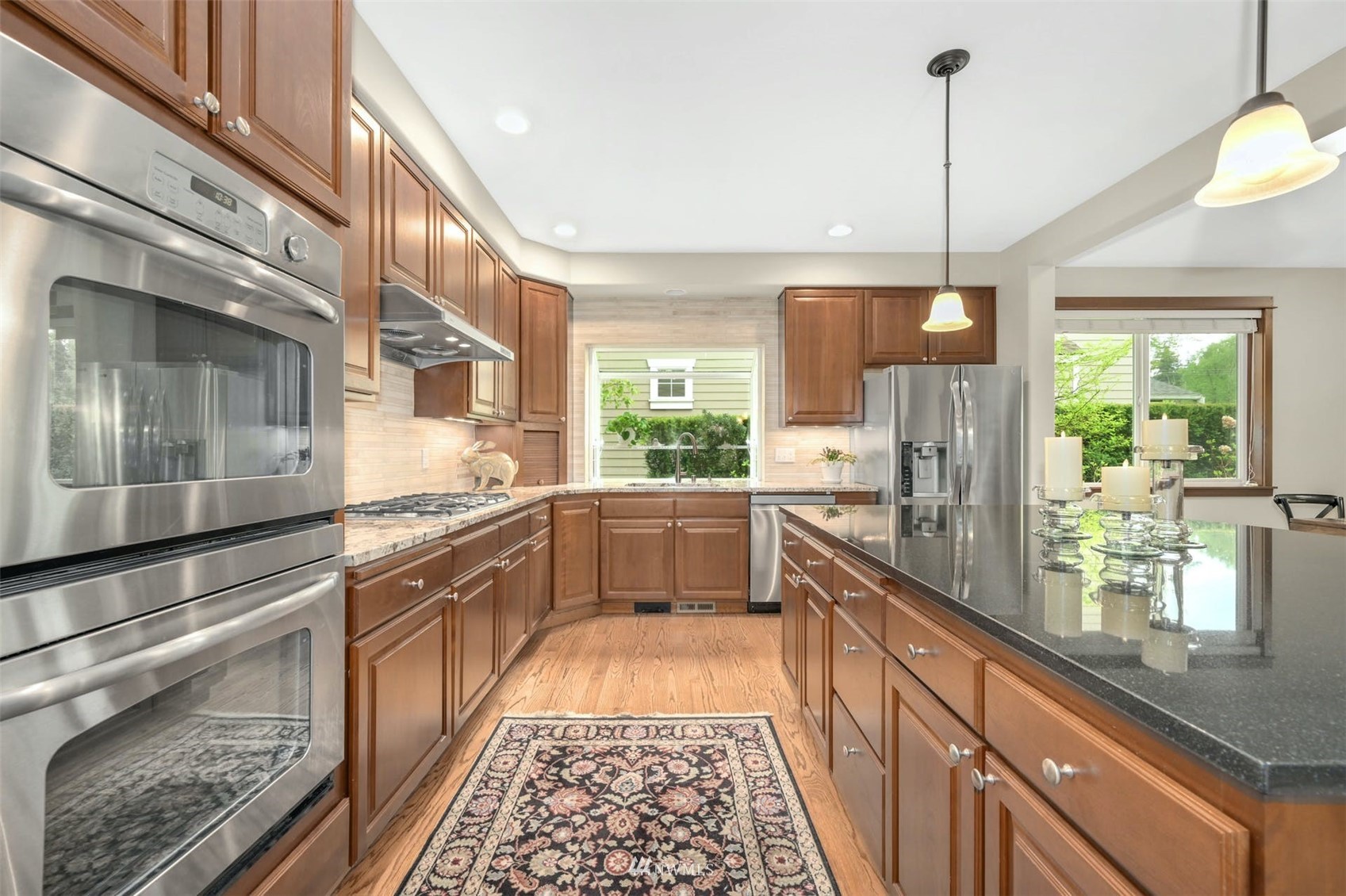 22722 16th Avenue West Bothell, WA 98021 - Photo 13 of 39 a kitchen with stainless steel appliances granite countertop a stove a sink and a refrigerator
