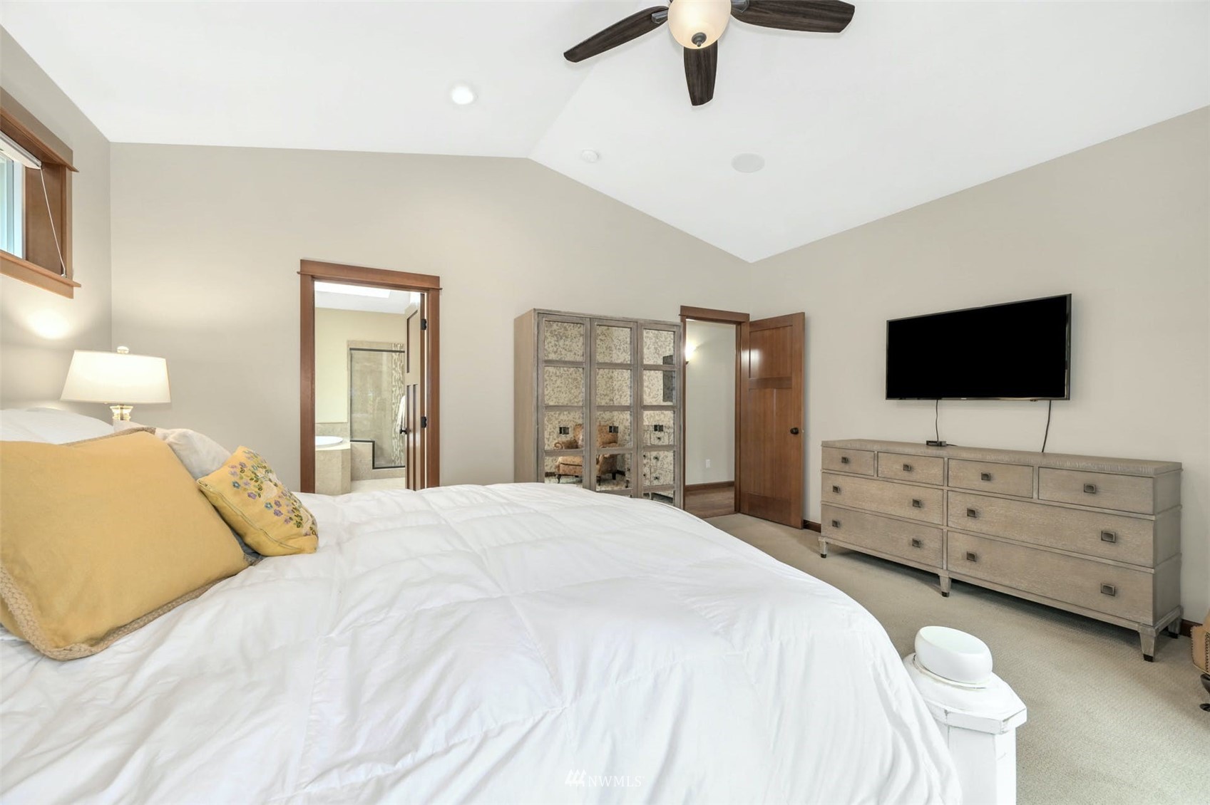 22722 16th Avenue West Bothell, WA 98021 - Photo 15 of 39 a large bedroom with a bed and flat tv screen on the dresser