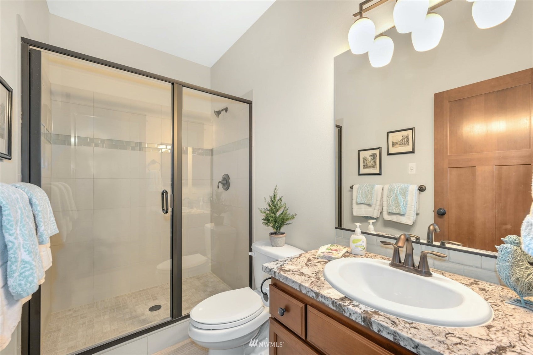 22722 16th Avenue West Bothell, WA 98021 - Photo 21 of 39 a bathroom with a granite countertop sink a toilet a mirror and shower