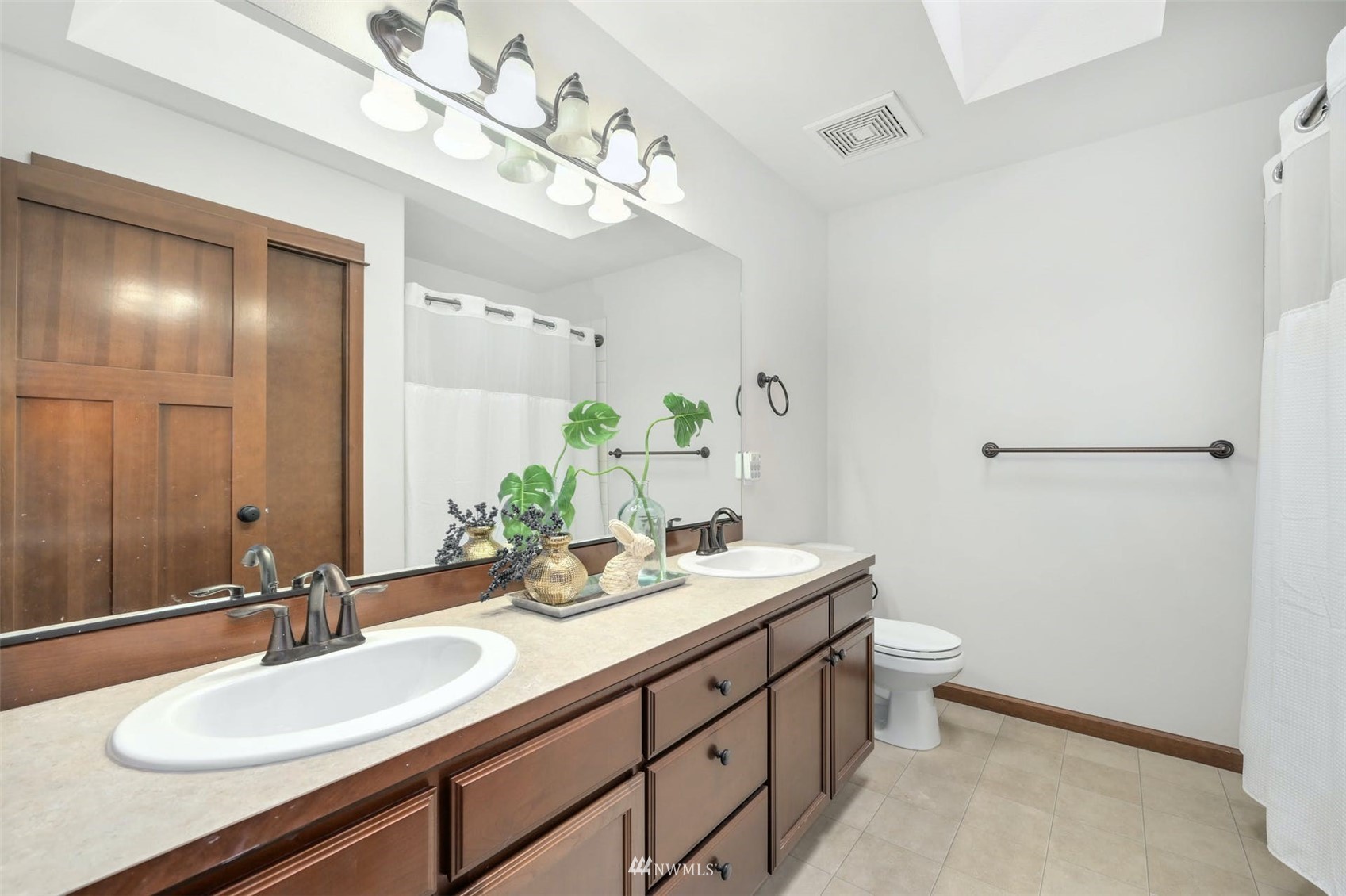 22722 16th Avenue West Bothell, WA 98021 - Photo 30 of 39 a bathroom with a double vanity sink and a mirror