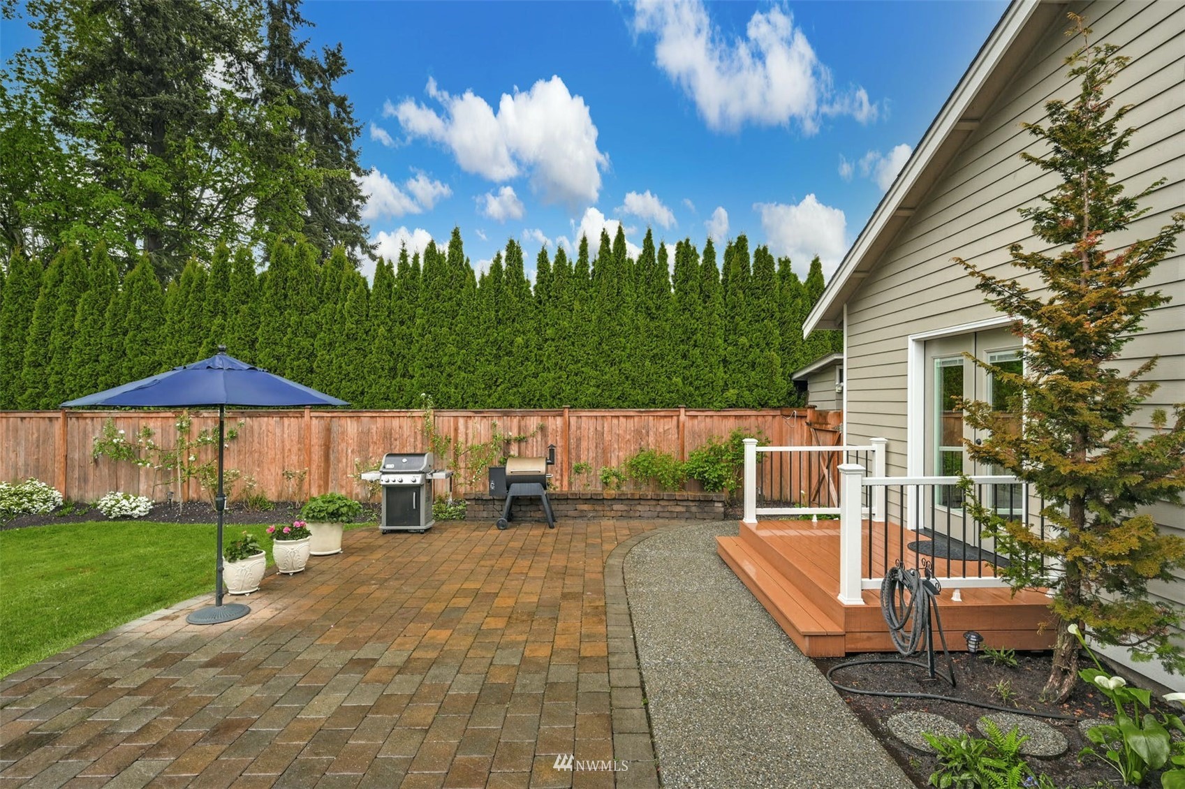 22722 16th Avenue West Bothell, WA 98021 - Photo 33 of 39 a view of a patio with a table and chairs under an umbrella