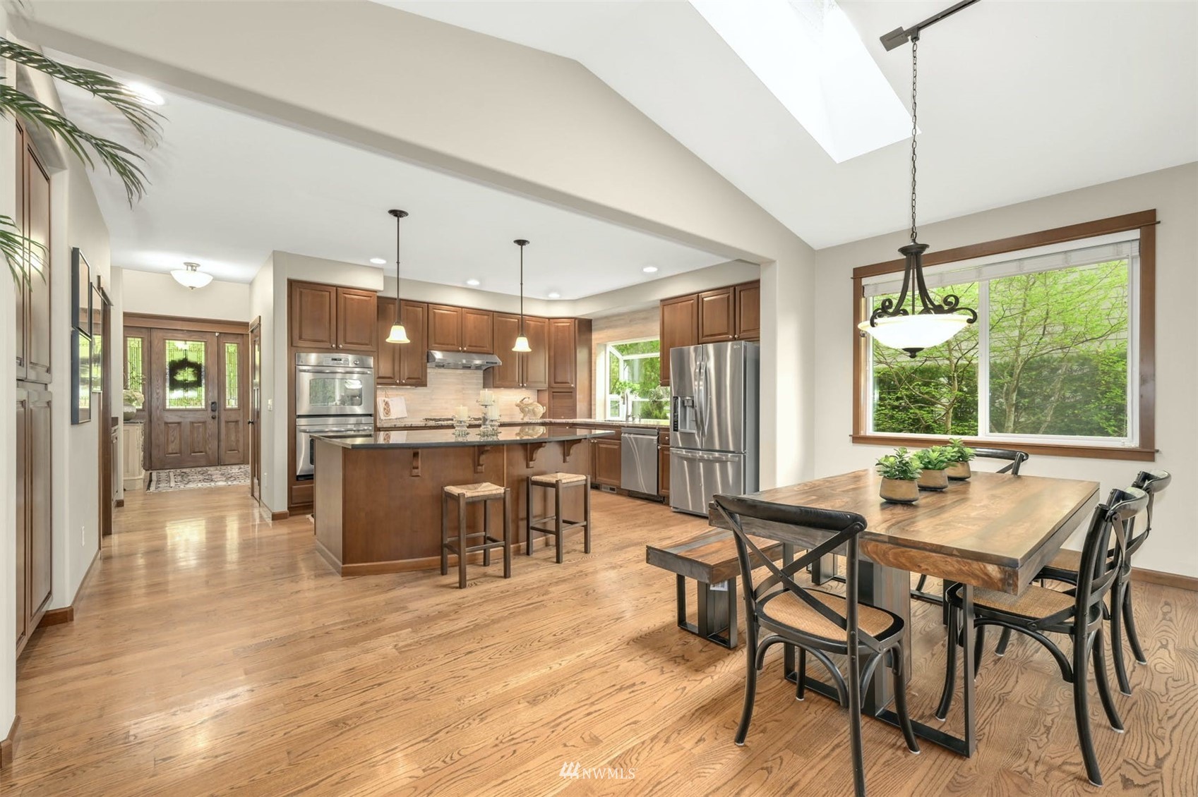 22722 16th Avenue West Bothell, WA 98021 - Photo 10 of 39 a dining hall with stainless steel appliances kitchen island a table and chairs in it
