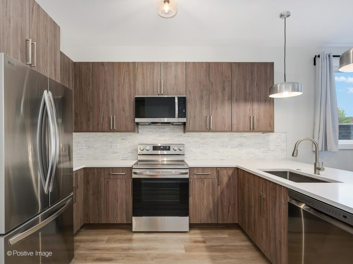 3956 South Indiana Avenue, Unit 1F Chicago, IL 60653 - Photo 4 of 12 a kitchen with stainless steel appliances a stove a sink and a refrigerator