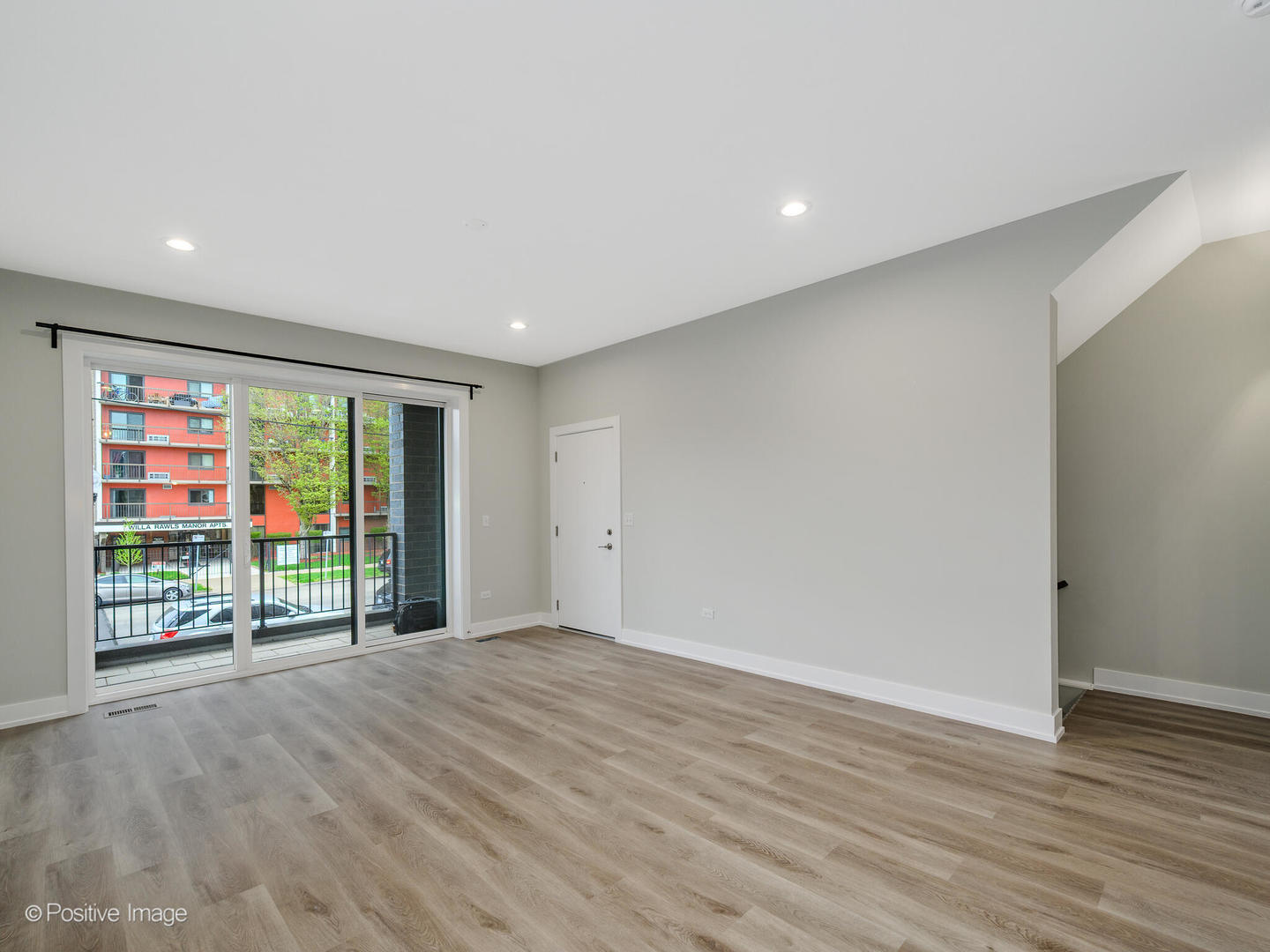 3956 South Indiana Avenue, Unit 1F Chicago, IL 60653 - Photo 7 of 12 a view of an empty room with wooden floor and a window
