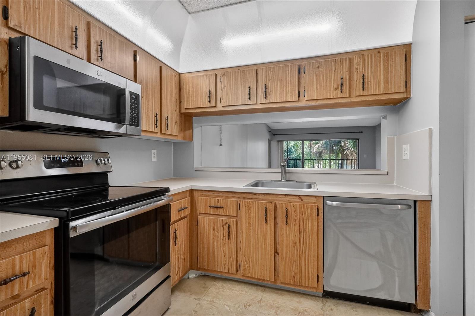 491 Ives Dairy Road, Unit 3065 Miami, FL 33179 - Photo 11 of 41 a kitchen with stainless steel appliances granite countertop a stove microwave and cabinets