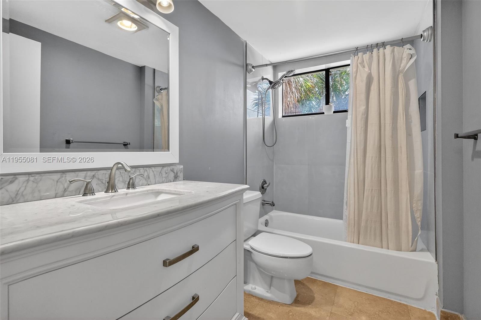 491 Ives Dairy Road, Unit 3065 Miami, FL 33179 - Photo 16 of 41 a bathroom with a toilet a sink a mirror a bathtub and vanity