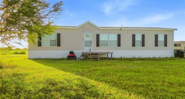a view of a house with a backyard