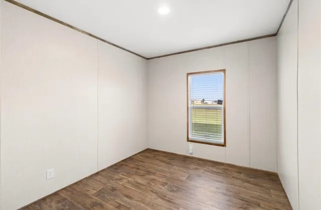 an empty room with windows and closet