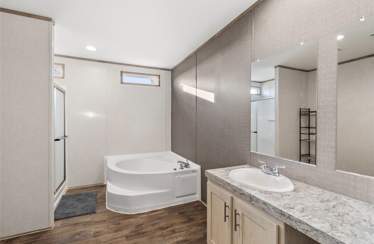 43 Ironwood Road Victoria, TX 77904 - Photo 16 of 21 a bathroom with a granite countertop sink a mirror and a bathtub
