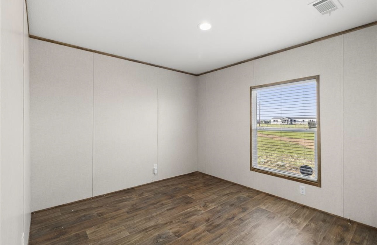 43 Ironwood Road Victoria, TX 77904 - Photo 18 of 21 an empty room with wooden floor and windows