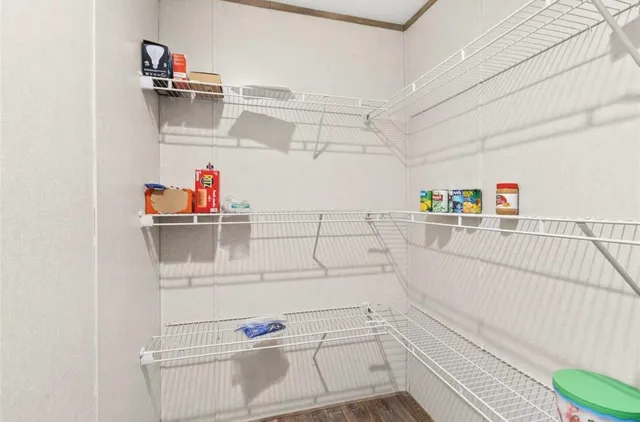 a view of walk in closet and empty room