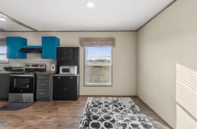 a kitchen with stainless steel appliances granite countertop a stove a refrigerator and a sink