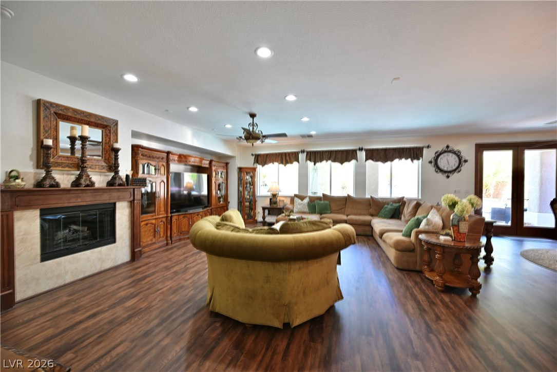 2729 Kildrummie Street Henderson, NV 89044 - Photo 21 of 42 Rich hardwood flooring complements a fireplace with a decorative mantel and built-in entertainment center in this gathering room.