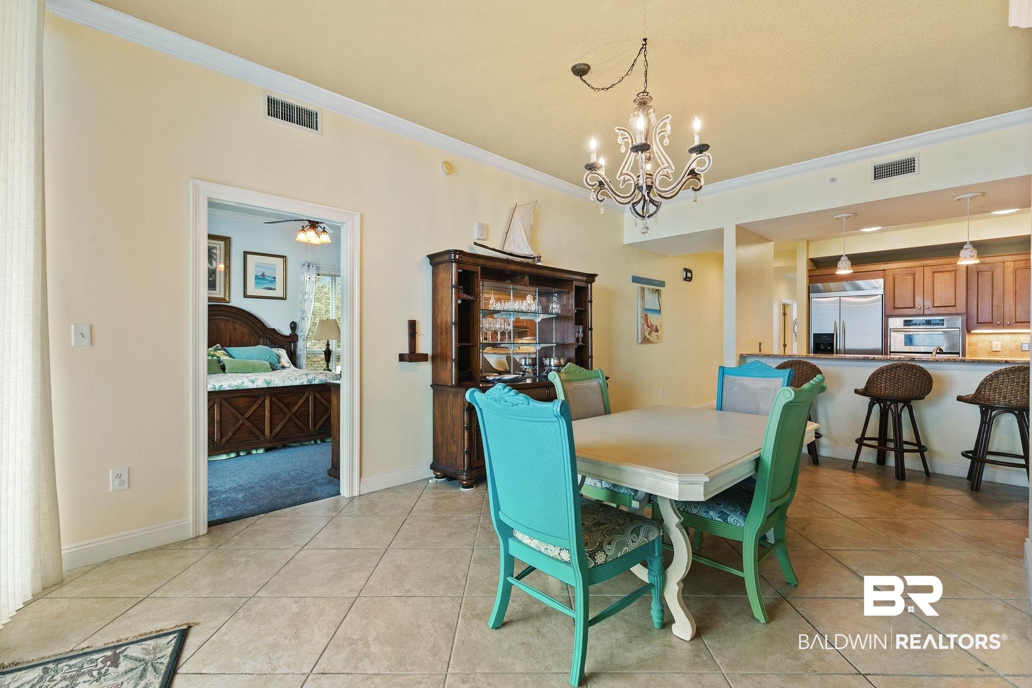 28250 Canal Road, Unit 208 Orange Beach, AL 36561 - Photo 9 of 53 Dining space with crown molding, suspended lighting, light tile patterned floors, and a ceiling fan