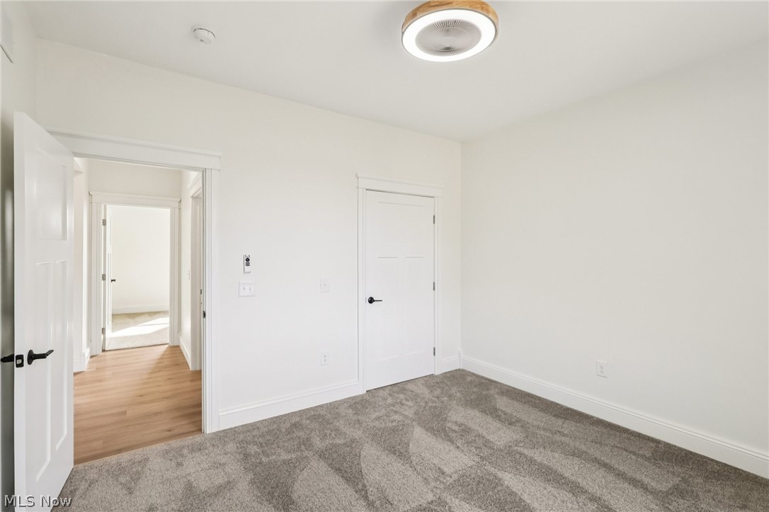 6535 North Ridge Road West Geneva, OH 44041 - Photo 22 of 48 Unfurnished bedroom with light carpet and baseboards