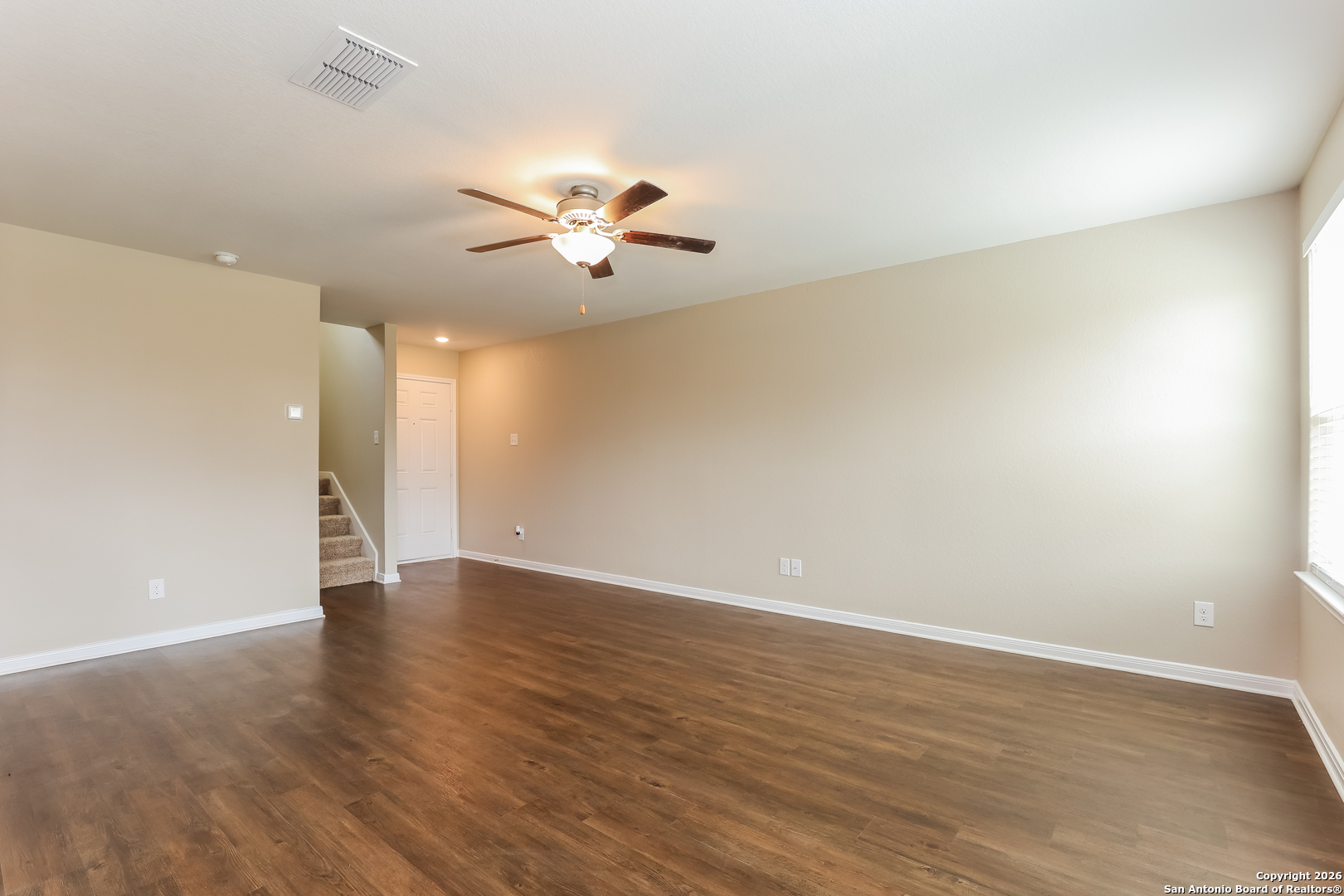 7213 Romaire San Antonio, TX 78252 - Photo 12 of 15 an empty room with wooden floor fan and windows