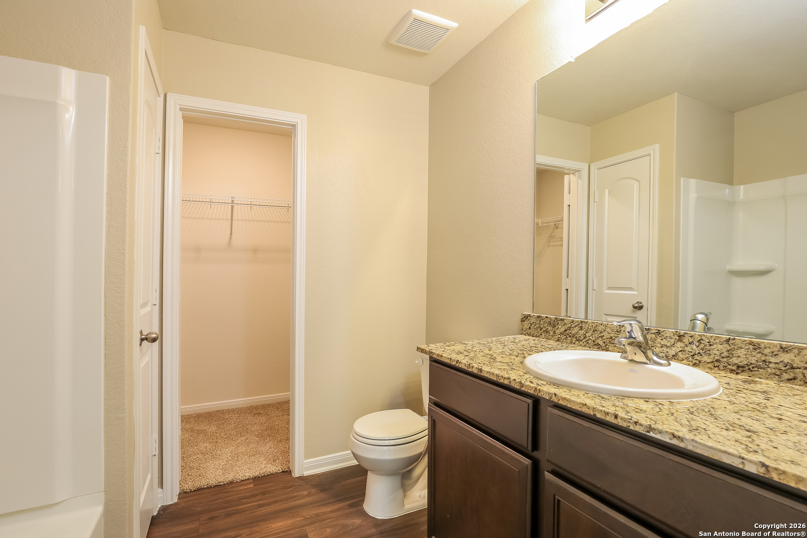 7213 Romaire San Antonio, TX 78252 - Photo 13 of 15 a bathroom with a granite countertop sink toilet and shower