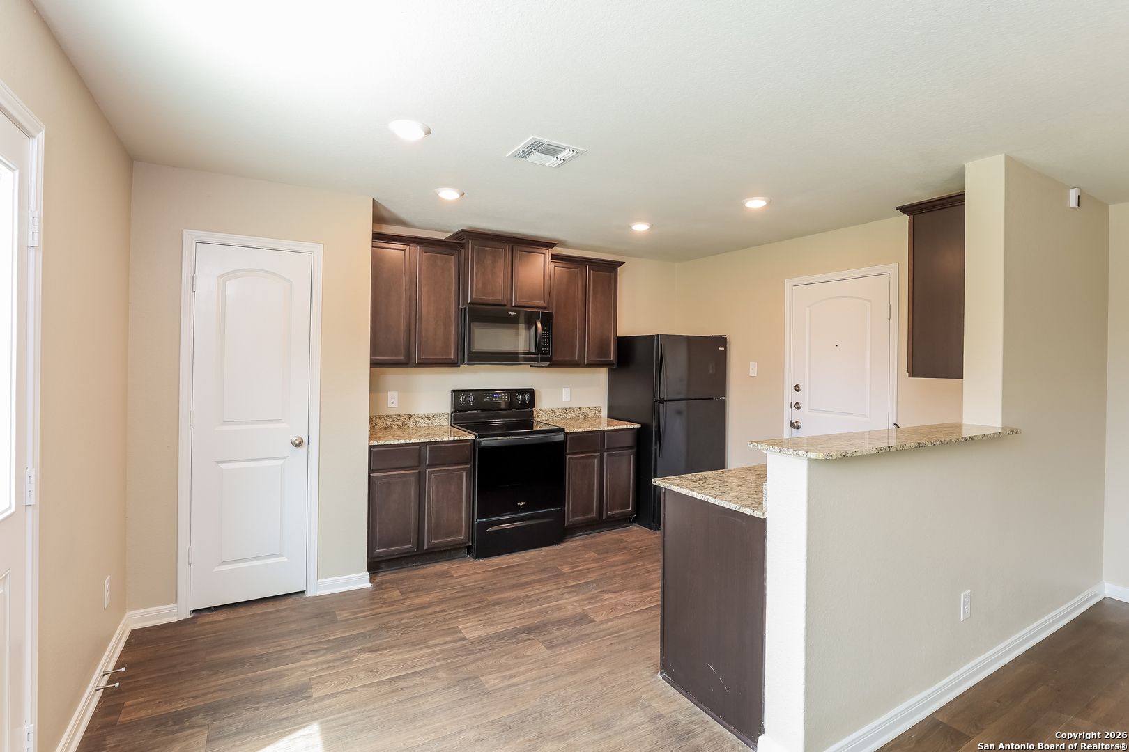 7213 Romaire San Antonio, TX 78252 - Photo 4 of 15 a kitchen with stainless steel appliances granite countertop a refrigerator stove top oven and sink