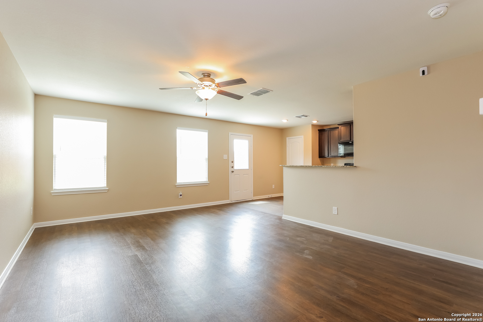 7213 Romaire San Antonio, TX 78252 - Photo 8 of 15 a view of an empty room with a window and wooden floor