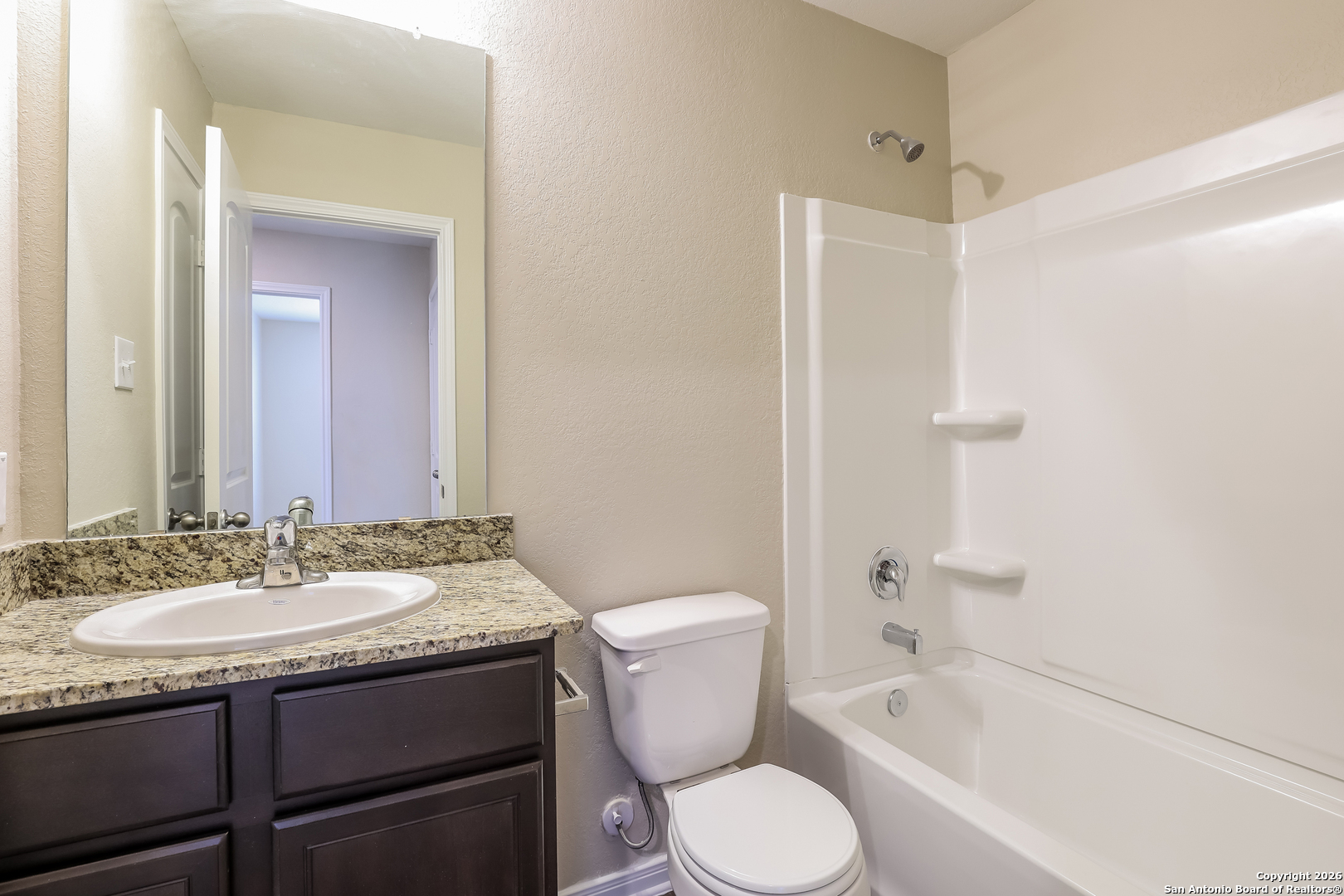 7213 Romaire San Antonio, TX 78252 - Photo 9 of 15 a bathroom with a bathtub shower sink mirror and toilet