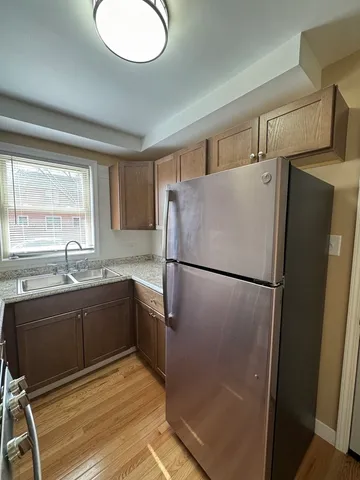 a kitchen with a refrigerator sink and cabinets