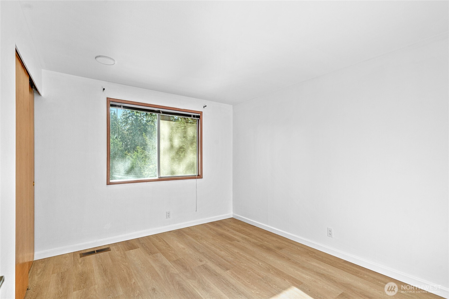 5824 111th Place Southwest Mukilteo, WA 98275 - Photo 19 of 38 an empty room with wooden floor and windows